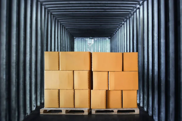 Packaging Boxes Stacked on Pallets Loading inside Cargo Container. Cartons, Cardboard Boxes. Shipment Goods.Shipping Freight Trucks. Distribution Supplies Warehouse. Truck Transport Logistics