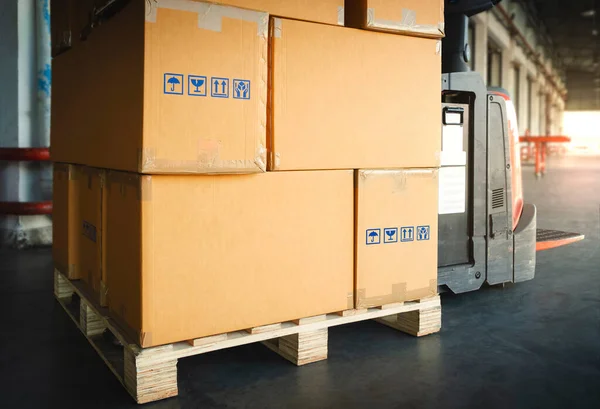 Packaging Boxes Stacked on Wooden Pallet in Warehouse. Cartons, Cardboard Boxes. Shipment Goods. Shipping Cargo Supplies Warehouse Logistics.