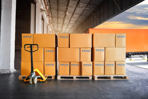 Packaging Boxes Stacked on Pallets Wating to Loading into Cargo Container. Cartons, Cardboard Boxes. Delivery Shipping Trucks. Supply Chain Shipment Goods. Distribution Supplies Warehouse Logistics.