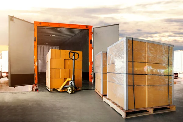 Packaging Boxes Stacked on Pallets Loading into Cargo Container. Delivery Shipping Trucks. Supply Chain Shipment Goods. Distribution Supplies Warehouse. Freight Truck Transport Logistics