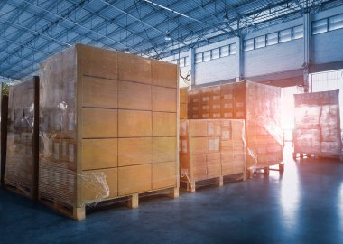 Packaging Boxes Wrapped Plastic Stacked on Pallets in Storage Warehouse. Supply Chain. Storehouse Distribution. Cargo Shipping Supplies Warehouse Logistics.