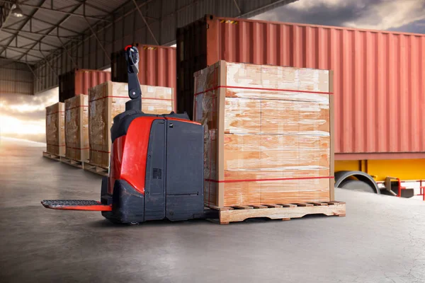 Electric Forklift Pallet Jack with Packaging Boxes Stacked on Pallet. Cargo Shipment. Delivery, Loading Container Trucks. Distribution Supplies Warehouse. Freight Truck Logistics Cargo Transport