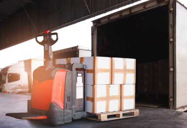 Packaging Boxes Stacked on Pallet with Electric Forklift Pallet Jack. Cartons Cardboard Boxes. Supply Chain. Shipping Warehouse. Supplies Warehouse Logistics.