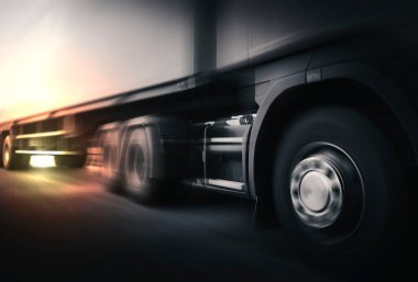 Fast Motion Speed of Semi TrailerTruck Driving on The Road. Shipping Container Trucks. Commercial Truck Transport. Engine Diesel Trucks. Freight Trucks Logistics Cargo Transport