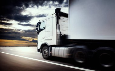 Semi TrailerTruck Driving on Road with Sunset Sky. Shipping Container Trucks. Commercial Truck Transport. Delivery. Engine Diesel Trucks. Lorry Tractor. Freight Trucks Logistics Cargo Transport