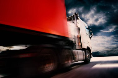 Fast Speed of Semi TrailerTruck Driving on Road with Sunset Sky. Shipping Container. Commercial Truck Transport. Delivery. Lorry Tractor. Freight Trucks Logistics Cargo Transport