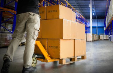 Workers Unloading Package Boxes on Pallets in Storage Warehouse. Cartons, Parcel Boxes. Pallet Jack Loader. Shipping Supplies Warehouse. Supply Chain Shipment Goods. Warehouse Distribution Logistics