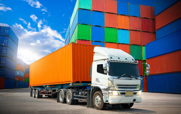 Semi trailer Truck Parked with Row of Stacked Containers Cargo Shipping. Handling of Logistics Transportation Industry. Cargo Container ships, Freight Trucks Import-Export. Distribution Warehouse.