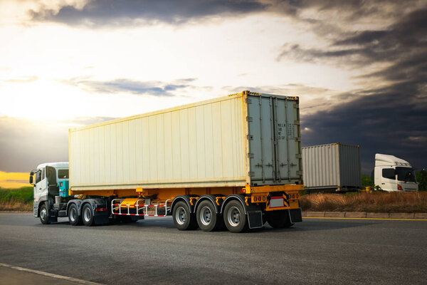 Semi Trailer Truck Driving on Highway Road with The Sunset. Shipping Container Trucks. Commercial Truck Transport. Delivery. Diesel Lorry Tractor. Freight Trucks Logistics Cargo Transport.