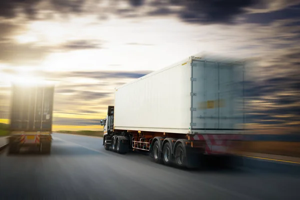 Speed Motion of Semi Trailer Truck Driving on The Road with The Sunset. Commercial Truck, Express Delivery Transit. Shipping Container Truck Transport. Freight Trucks Logistics Cargo Transport.