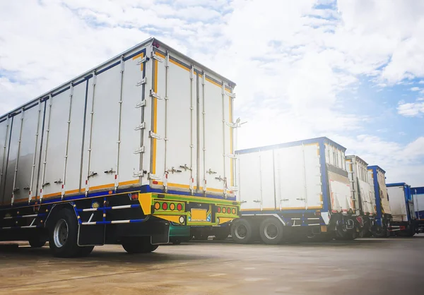 Row of Cargo Container Trucks on The Parking Lot. Lifting Ramp Trucks. Commercial Transport Lorry, Distribution Warehouse Shipping. Freight Truck Logistic, Cargo Transport.