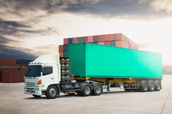Semi trailer Truck on The Parking Lot, Stacked of Containers Cargo Shipping. Handling of Logistics Transportation Industry. Cargo Container ships, Freight Trucks Import-Export. Distribution Warehouse.