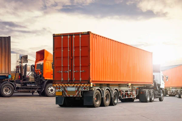 Semi trailer Truck on The Parking Lot at Warehouse. Shipping Warehouse. Handling of Logistics Transportation Industry. Cargo Container ships, Freight Trucks Import-Export. Distribution Warehouse.
