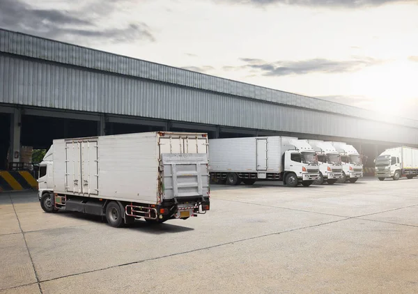 Container Trucks on The Parking Lot at Warehouse. Trucks Loading at Dock Warehouse. Shipping Cargo Container Delivery Trucks. Distribution Warehouse. Freight Trucks Logistic, Cargo Transport.