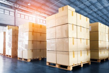 Package Boxes Stacked on Pallets in Storage Warehouse. Storehouse Distribution Storage Tall Shelf. Supply Chain. Shipping Supplies Warehouse Cargo Logistics.