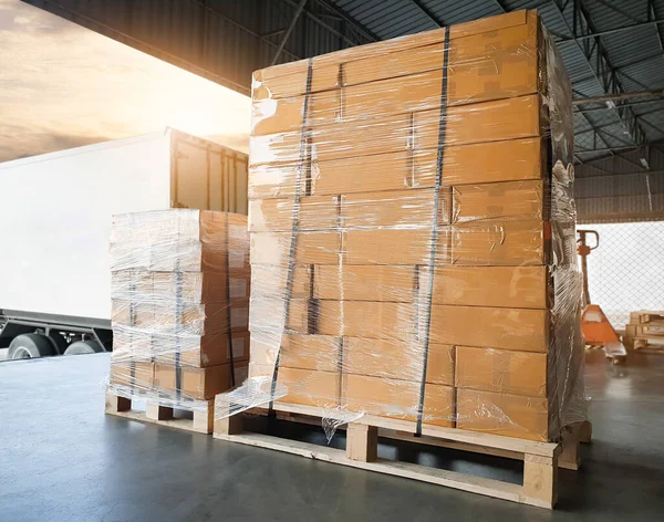 Package Boxes Stacked on Pallets Loading into Cargo Container. Warehouse Dock, Distribution Supplies Shipping, Supply Chain Shipment Boxes. Freight Truck Logistic Cargo Transport.