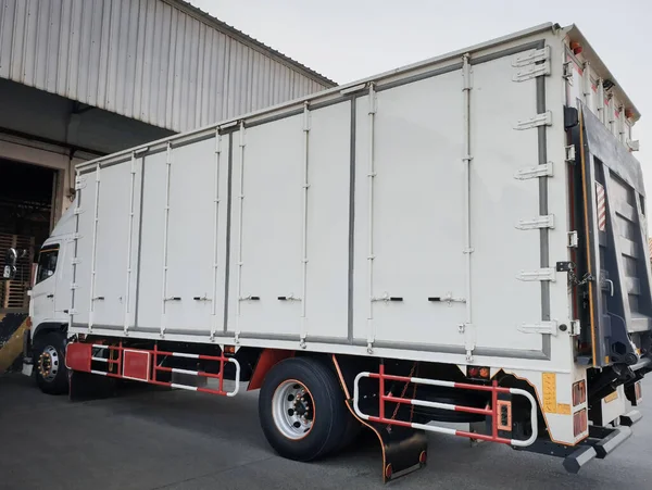 Cargo Container Trucks on The Parking Lot. Lifting Ramp Trucks. Commercial Transport Lorry. Shipping Delivery Trucks. Distribution Warehouse. Freight Truck Logistics Cargo Transport