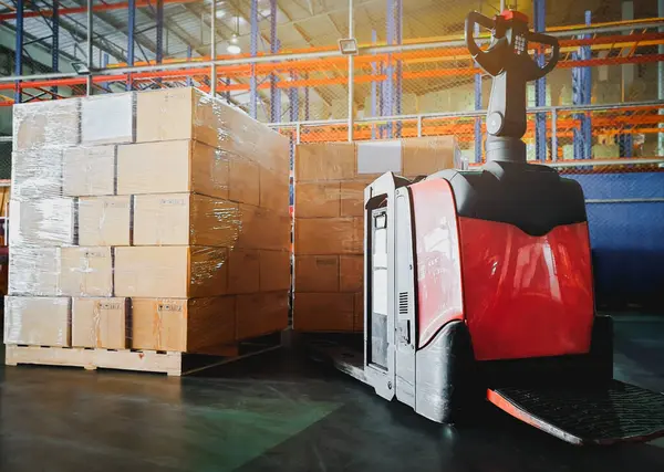 Electric Forklift Pallet Jack with Package Boxes Stack on Pallet. Forklift Loader. Storage Warehouse. Supply Chain. Shelf Storehouse Shipping Supplies Distribution. Warehouse Logistics.