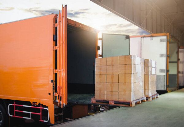 Package Boxes Stacked on Pallets Loading into Container Truck. Distribution Warehouse Shipping, Supply Chain Supplies, Shipment. Freight Truck Logistics Transport.