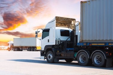Sunset Sky ile park alanında yarı karavan kamyonları. Traktör kamyonu. Ekonomik İş Taşımacılığı Yolda. Nakliye Konteynırı İthalatı - İhraç. Depo Limanı. Kamyonculuk. Yük Lojistik Taşımacılığı