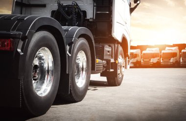 Limandaki park yerinde yarı kamyonlar var. Yarı kamyon traktörü, Big Rig. Kamyon Tekerleği. Nakliye İthalat-İhracat. Kamyonculuk. Nakliye Aracı, Lojistik Taşımacılık.