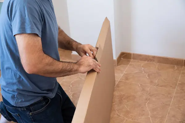 stock image Portrait of a man assembling furniture. Do it yourself furniture set.