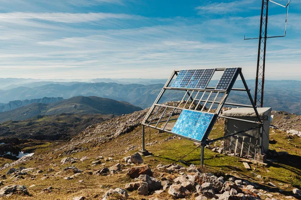 installation of solar panels on a mountain peak on a sunny day. green and snowy energy. solar energy.