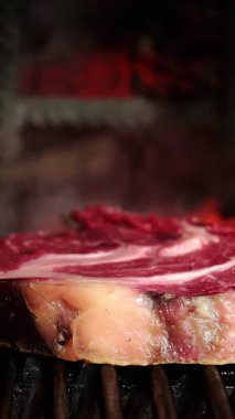 Yüksek ısıda ızgara ızgara pirzola, derin karamelize kabuk geliştirme ve profesyonel restoran ortamında zengin lezzet