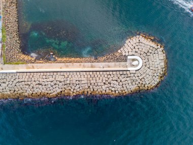 Beykoz Lisesi, liman girişini koruyan bir deniz manzarası. Liman kıyısının bir bölümünün havadan çekilmiş görüntüsü, birbirine kenetlenmiş beton blokların eğimli bir yapı oluşturduğunu gösteriyor. POYRAZKOY İSTANBUL 