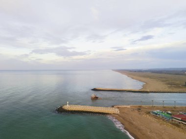 Coastal Estuary with Breakwaters and Vessels. High-angle view of a tranquil coastal estuary. Karasu Sakarya Adapazari Turkiye Turkey Drone shot Aerial view sunrise clipart