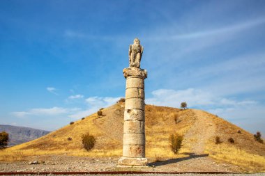 Nemrut, Adiyaman, Türkiye, 12 Ekim 2024: Güneşli bir günde Antik Bir Tepenin Üzerinde Antik Kalıntılar. Bir tepe üzerindeki antik kalıntıları keşfeden insanların görüntüsü seyahat bloglarına uygun güneş ışığıyla yıkanmış.