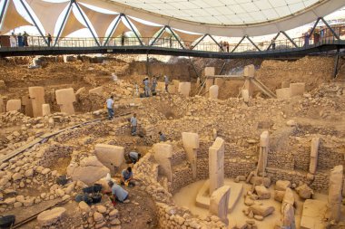 Archaeologists Unearth Ancient Secrets at Gobekli Tepe. Archaeologists meticulously excavate the prehistoric site of Gobekli Tepe in Turkey, revealing T-shaped pillars, circular enclosures, and stone clipart