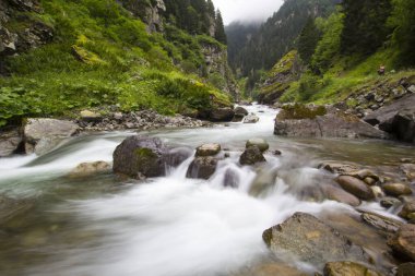 Stones in a stream with water blurred by long exposure