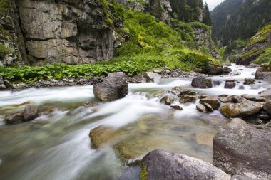 Stones in a stream with water blurred by long exposure
