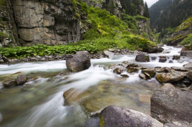 Stones in a stream with water blurred by long exposure