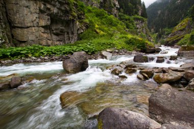Stones in a stream with water blurred by long exposure
