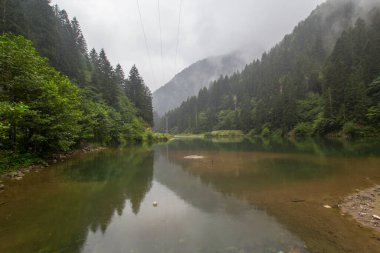 Reflections of mountains and green forest on stormy day on a foggy day landscape. One of the famous tourist spots Black Sea, Trabzon, Turkey. clipart