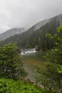 Reflections of mountains and green forest on stormy day on a foggy day landscape. One of the famous tourist spots Black Sea, Trabzon, Turkey. clipart