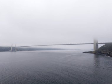 Yavuz Sultan Selim Köprüsü Suyun Üzerinde Puslu Köprü: Sisli bir arazide sakin bir köprü manzarası. Huzurlu bir manzarada bir su kütlesi genişleyen bir köprü, büyük olasılıkla bir nehir veya boğaz Türkiye 'yi gösteriyor