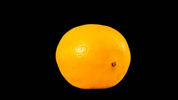 Fresh juicy yellow lemon isolated on black background. High quality photo