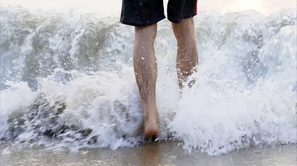 Man lags in the sea waves. Person in water. High quality photo