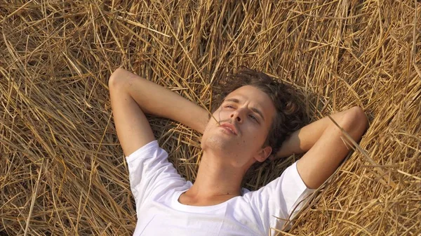 man is lying relaxed in a haystack. High quality photo