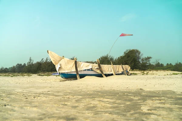 Fishermans boat covered with fabric on the sand. High quality photo