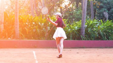 Genç bir kadın tenis kortunda servis atıyor. Yüksek kalite fotoğraf