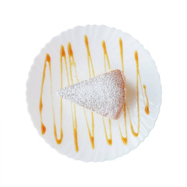 cheese cake topping with icing on white plate decorated by caramel sauce.