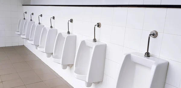 White urinal on white wall in men public toilet, washroom or rest room. Object, Interior design, Sanitary ware and Sanitation concept