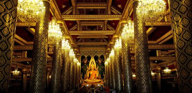 Big golden monk statue at Phitsanulok, Thailand. Beautiful interior design and art building in Thai ancient style. Landmark of travel for tourism people.