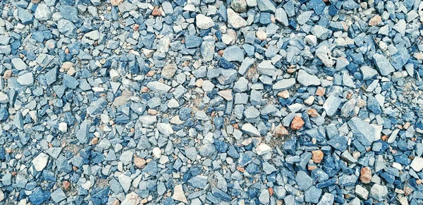 Pattern of small gravel, rock or stone on the ground for background in blue vintage color tone. Hard material, Art or Textured wallpaper and Group of object concept