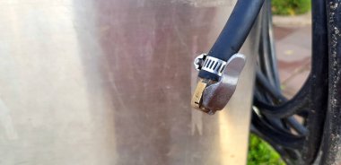 Lastik boşluğunu servis için asılı duran siyah kabloyla kapat. İnsanlar benzin istasyonunda solda fotokopi alanı olan bir araca, arabaya, motora, bisiklete rüzgar doldurmak istiyorlar. araç concepsi