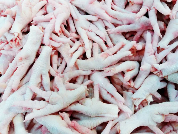 Many freshness chicken feet for sale at supermarket or market on street food. Fresh, uncook food and part of animal.